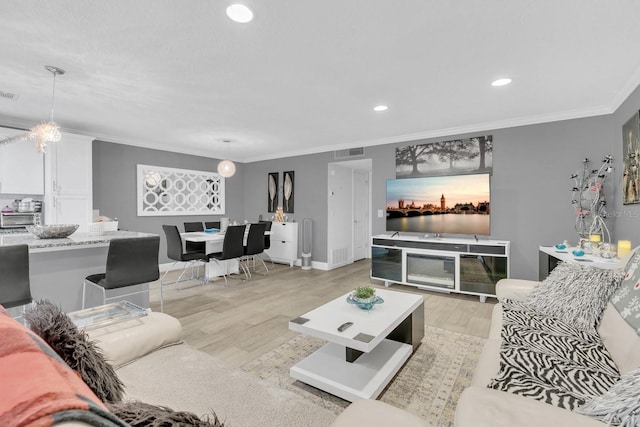 living room featuring light wood-type flooring and crown molding