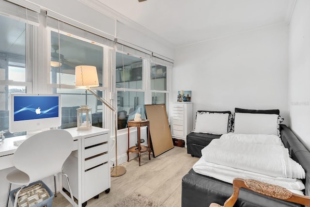 bedroom with ornamental molding and light hardwood / wood-style flooring