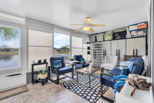 sunroom featuring ceiling fan