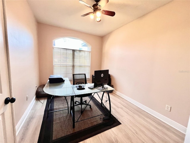 home office featuring light hardwood / wood-style flooring and ceiling fan