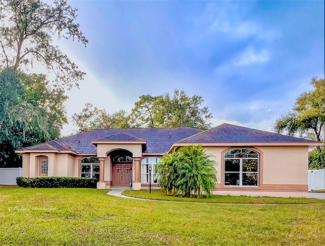 ranch-style home featuring a front yard