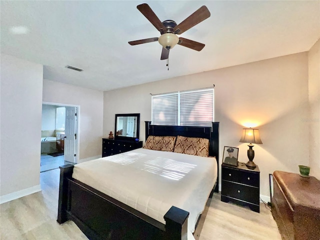 bedroom featuring light hardwood / wood-style floors, ensuite bath, and ceiling fan