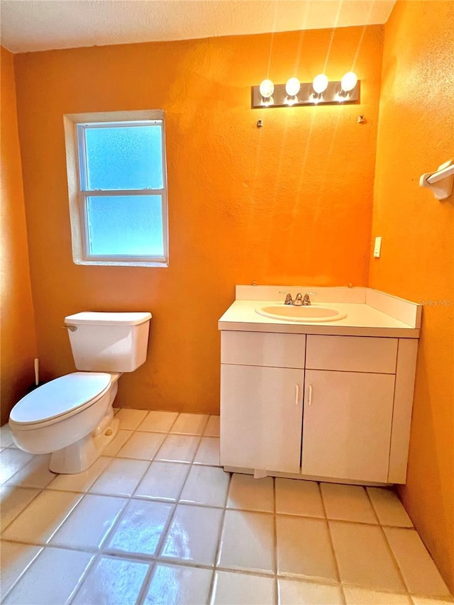 bathroom featuring toilet, vanity, and tile patterned floors