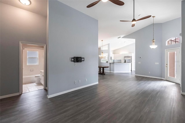 unfurnished living room with ceiling fan, dark hardwood / wood-style flooring, and high vaulted ceiling