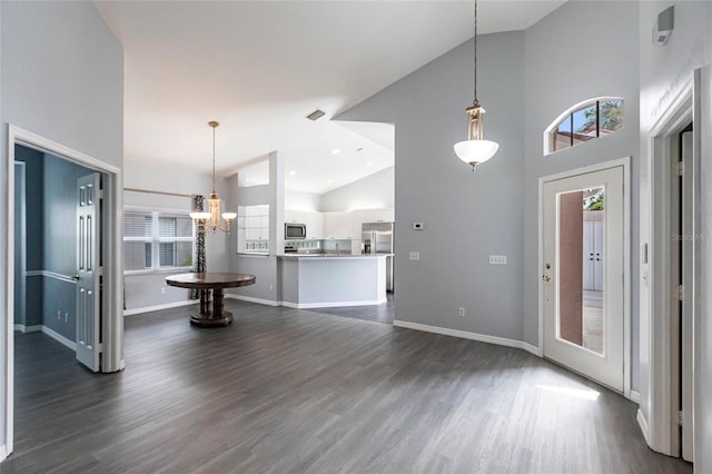 interior space with a notable chandelier, dark hardwood / wood-style floors, and high vaulted ceiling