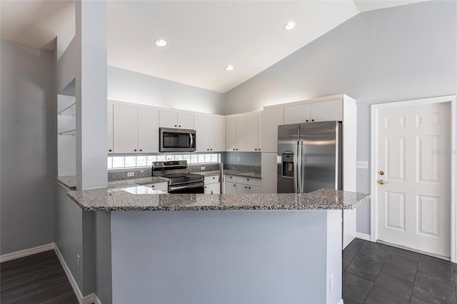 kitchen featuring kitchen peninsula, light stone counters, white cabinets, and appliances with stainless steel finishes