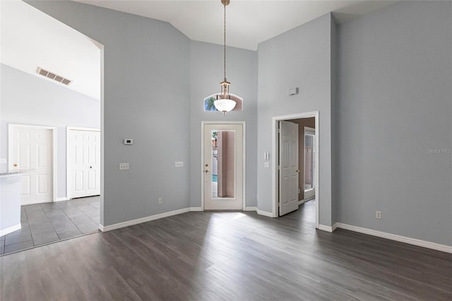 foyer featuring dark hardwood / wood-style flooring and high vaulted ceiling