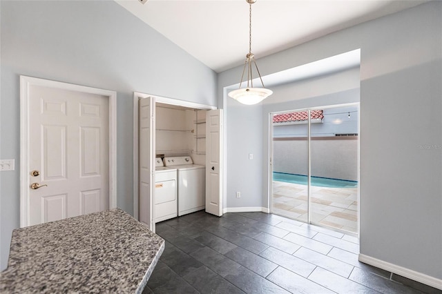 interior space featuring washing machine and clothes dryer and vaulted ceiling