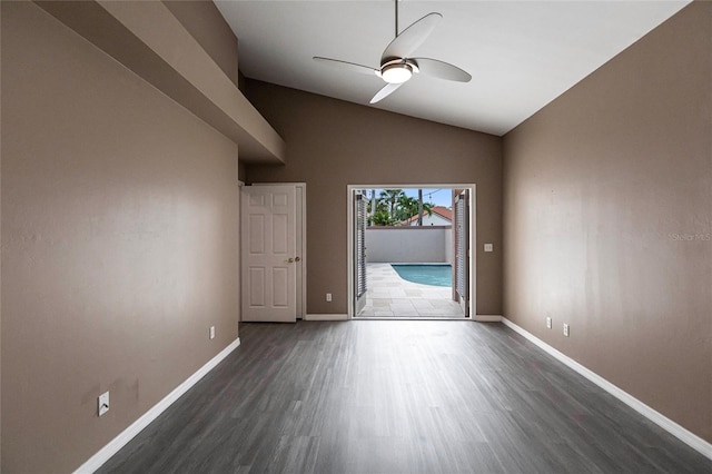 spare room with dark hardwood / wood-style flooring, ceiling fan, and lofted ceiling