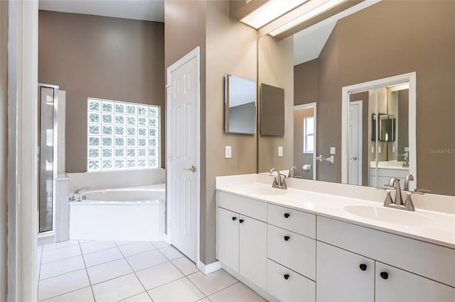 bathroom with tile patterned flooring, vanity, and a tub