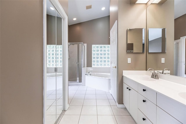 bathroom featuring tile patterned floors, vanity, and plus walk in shower