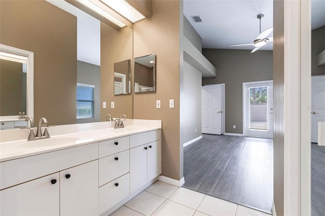 bathroom with wood-type flooring, vanity, vaulted ceiling, and ceiling fan