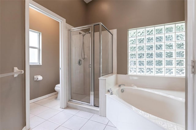 bathroom featuring a wealth of natural light, independent shower and bath, and toilet