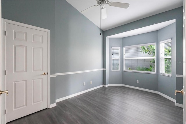 empty room with ceiling fan and dark hardwood / wood-style flooring