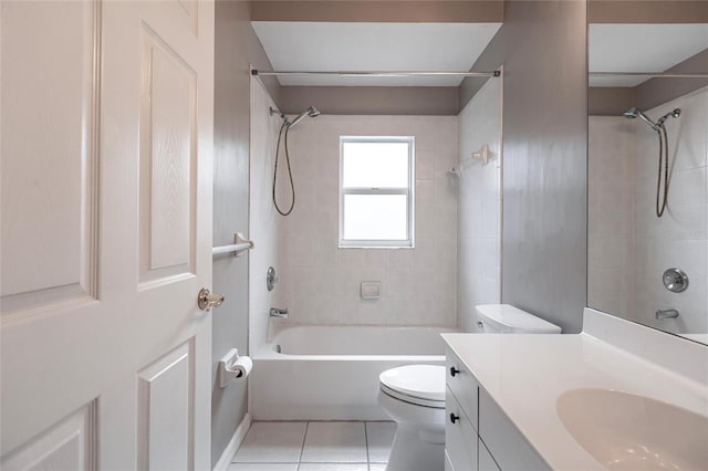 full bathroom with tile patterned floors, vanity, tiled shower / bath combo, and toilet