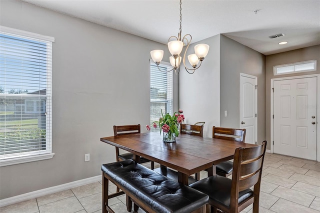 dining area featuring a chandelier and light tile patterned floors