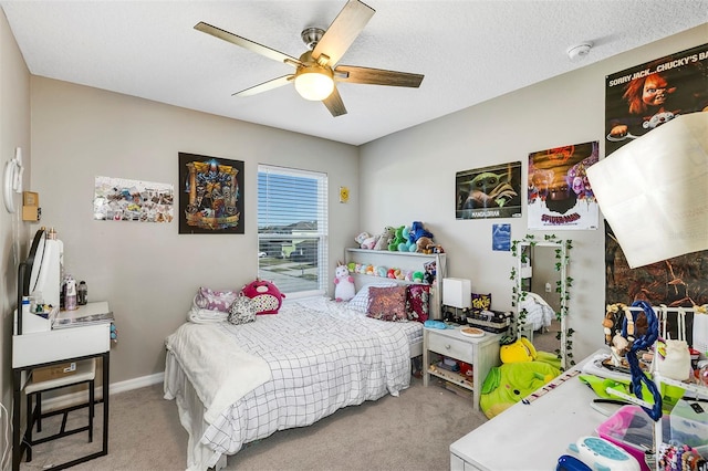 carpeted bedroom with ceiling fan and a textured ceiling