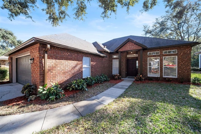 view of front of property featuring a front lawn and a garage