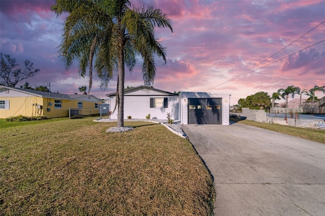 view of front of home featuring a garage and a yard