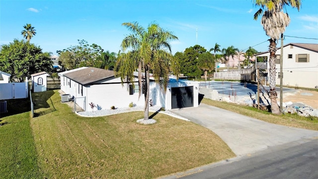 4059 Orient Dr, Hernando Beach, FL 34607 - view of front of house with driveway, cooling unit, a garage, and a swimming pool