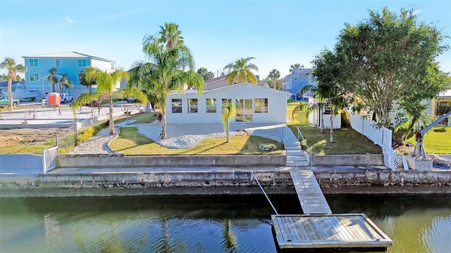 dock area with a lawn and a water view