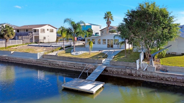 dock area with a yard and a water view