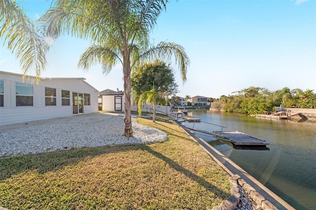 exterior space with a water view and a lawn