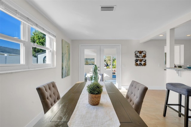 dining space with french doors and a healthy amount of sunlight