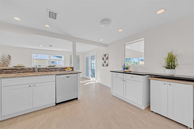 kitchen with white cabinets, white dishwasher, a wealth of natural light, and sink