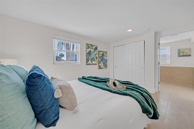 4059 Orient Dr, Hernando Beach, FL 34607 - bedroom with light tile patterned floors, multiple windows, recessed lighting, a closet, and baseboards