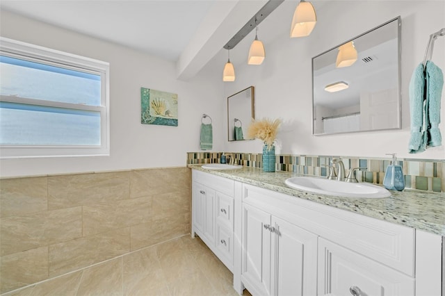 bathroom with tile patterned flooring, vanity, and tile walls