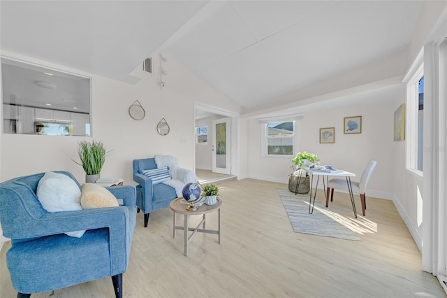 living room with light hardwood / wood-style flooring and lofted ceiling