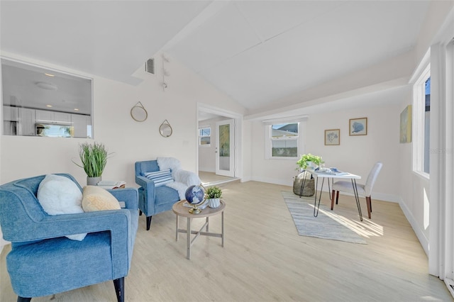 4059 Orient Dr, Hernando Beach, FL 34607 - living area featuring light wood finished floors, vaulted ceiling, and baseboards