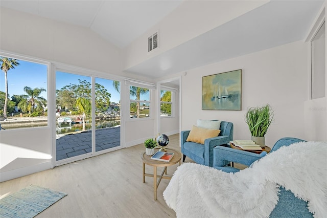 sunroom / solarium featuring lofted ceiling