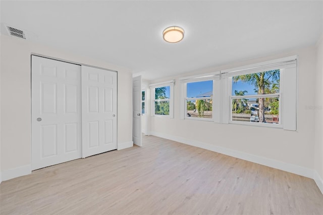 4059 Orient Dr, Hernando Beach, FL 34607 - unfurnished bedroom featuring baseboards, wood finished floors, and a closet