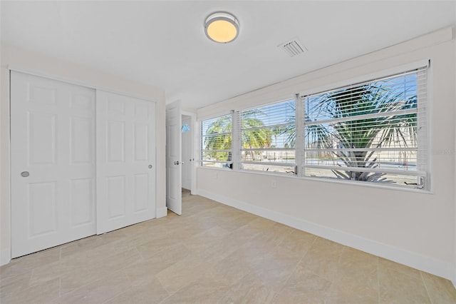 unfurnished bedroom with a closet