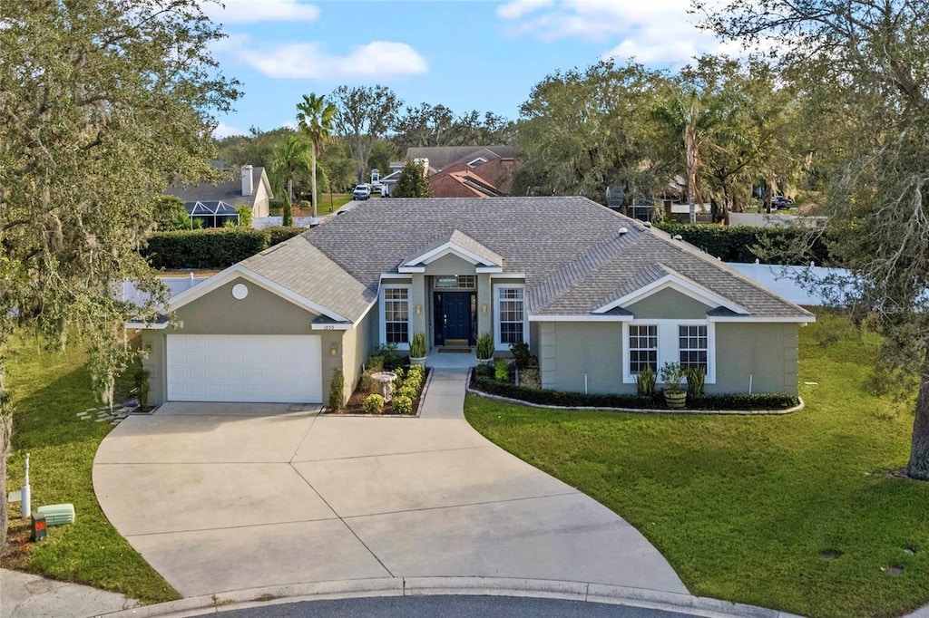 ranch-style house featuring a front yard and a garage