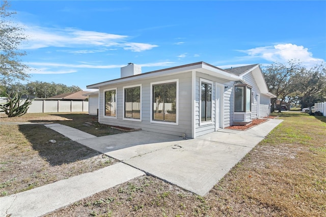 view of property exterior featuring a patio area and a yard