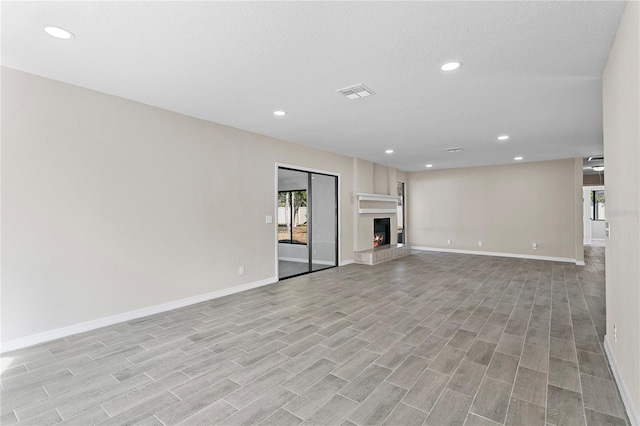 unfurnished living room with a textured ceiling