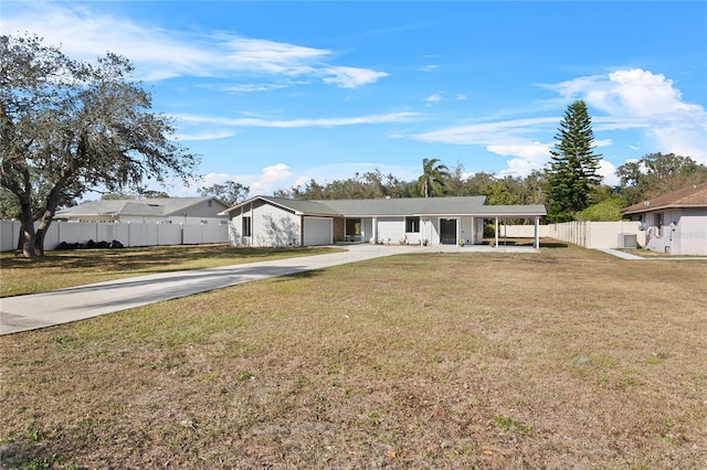 ranch-style house featuring a carport and a front yard