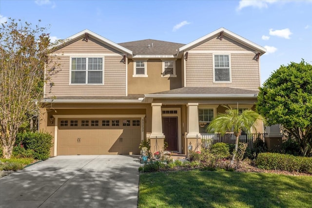 view of front of property with a garage and a front yard