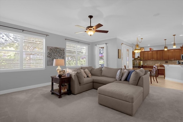 living room with ceiling fan and light carpet