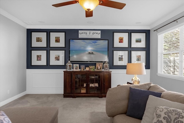 living room with ceiling fan, light colored carpet, and ornamental molding