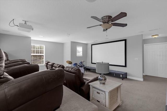 cinema room with light carpet, plenty of natural light, and ceiling fan