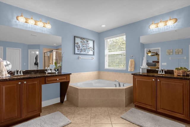 bathroom featuring tile patterned flooring, vanity, and shower with separate bathtub