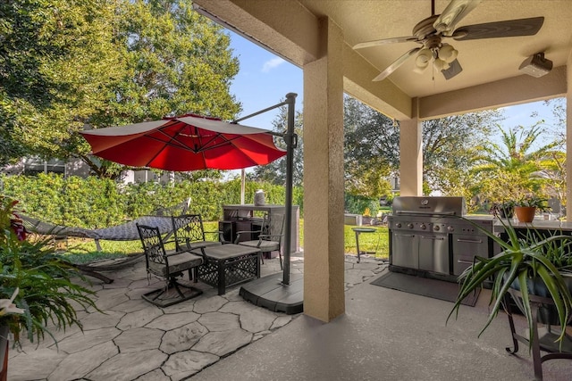 view of patio with grilling area, ceiling fan, and an outdoor kitchen