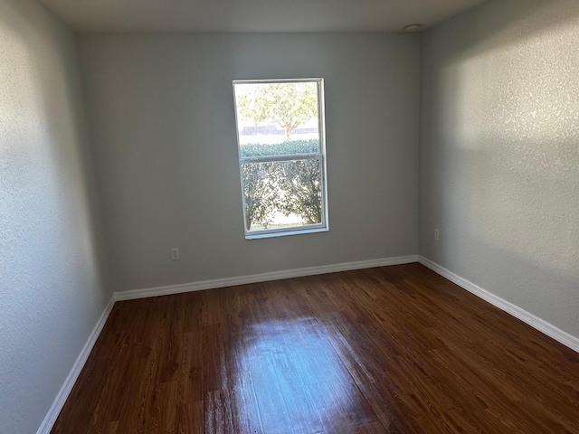 empty room featuring dark hardwood / wood-style flooring