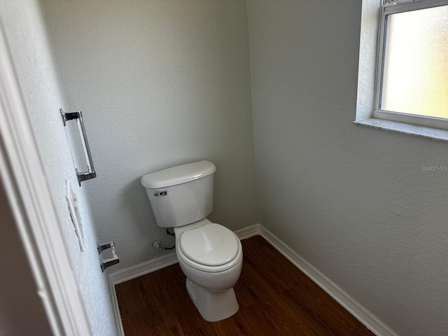 bathroom featuring toilet and wood-type flooring