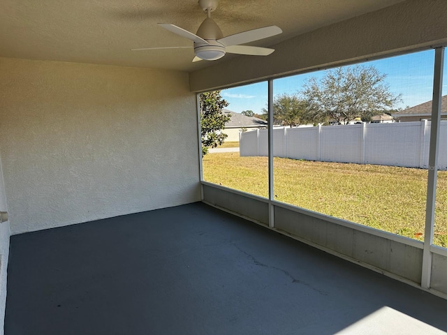 unfurnished sunroom with ceiling fan