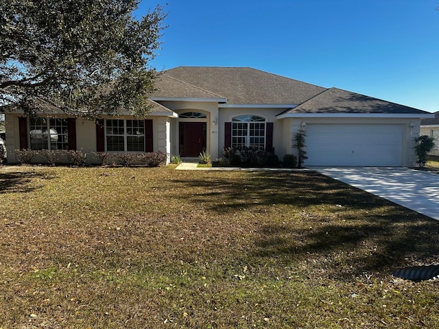 single story home featuring a garage and a front lawn